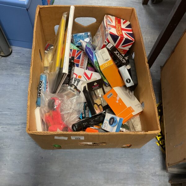 Mixed lot of vapes and makeup items in a cardboard box.