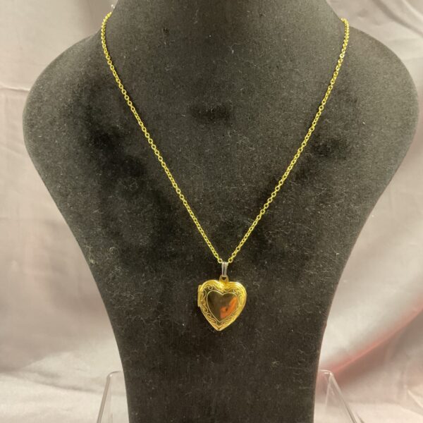 Gilt heart locket necklace on silver chain, vintage style.