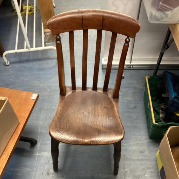 Dark wood vintage chair with spindle back for farmhouse style.