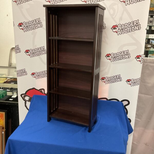 Dark wood bookshelf with three tiers for display and storage.