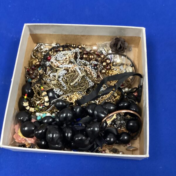 Assortment of vintage costume jewellery including necklaces and brooches.