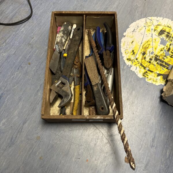 Vintage tool tray with a collection of antique hand tools.