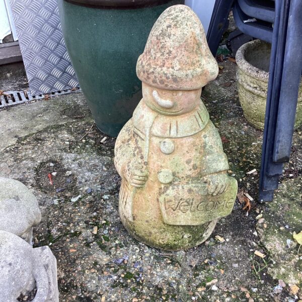 Vintage snowman garden ornament with weathered patina.