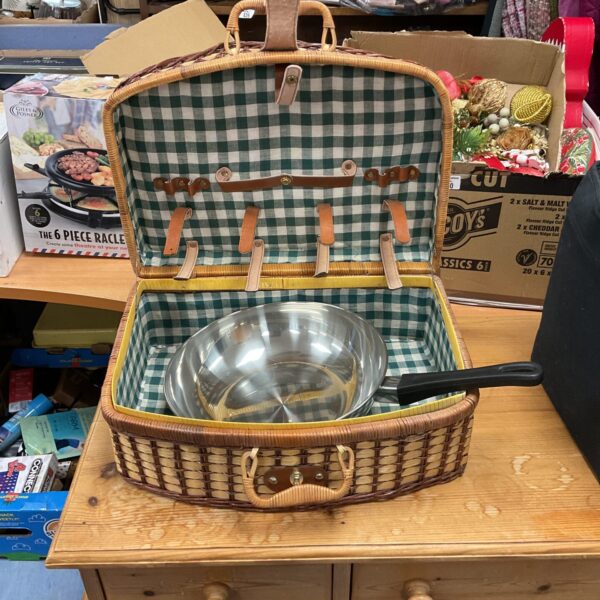 Vintage wicker picnic basket with stainless steel pan inside.
