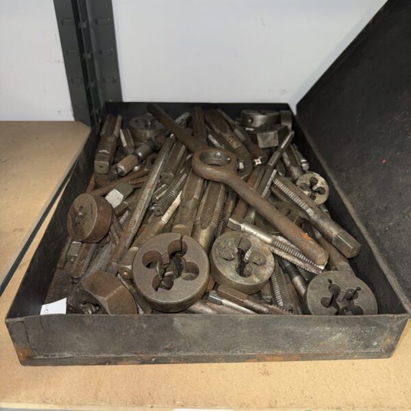 Vintage taps and dies set for metalworking and threading applications.