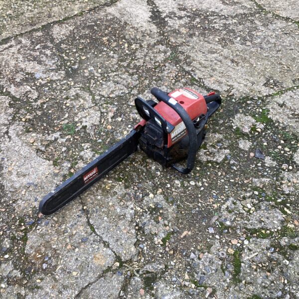 Side view of an MTD petrol chainsaw, a garden power tool.