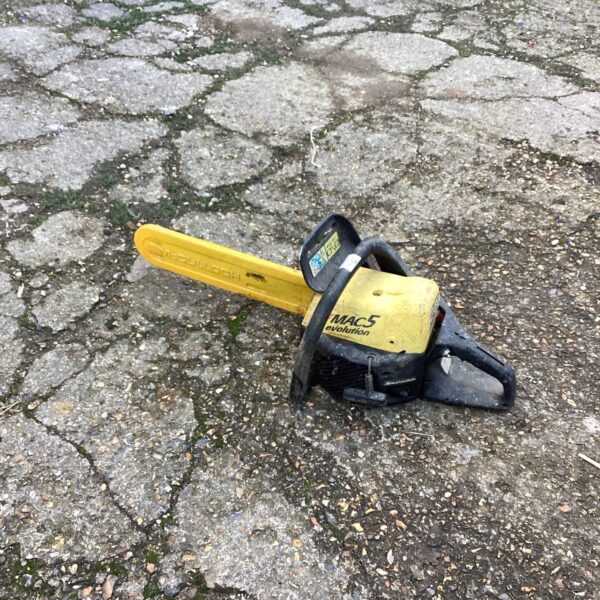 Yellow McCulloch petrol chainsaw, vintage garden tool for sale.