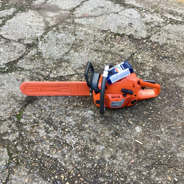Husqvarna 350 chainsaw with spare chain for garden and DIY tasks.