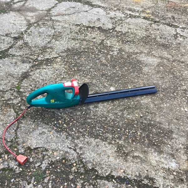 Bosch electric hedge cutter for garden trimming and maintenance.