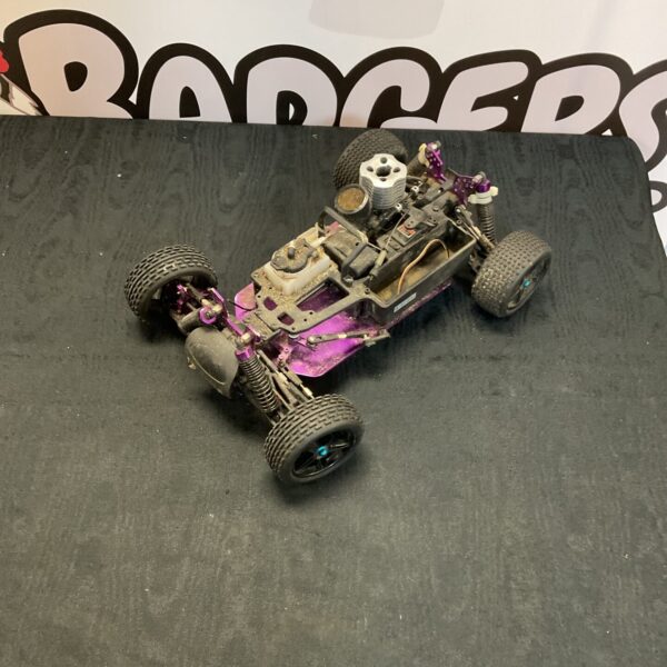 Purple RC buggy base with motor and suspension components.