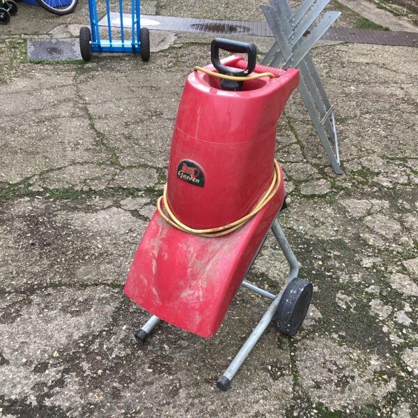 Red Power Devil garden shredder on a metal frame.