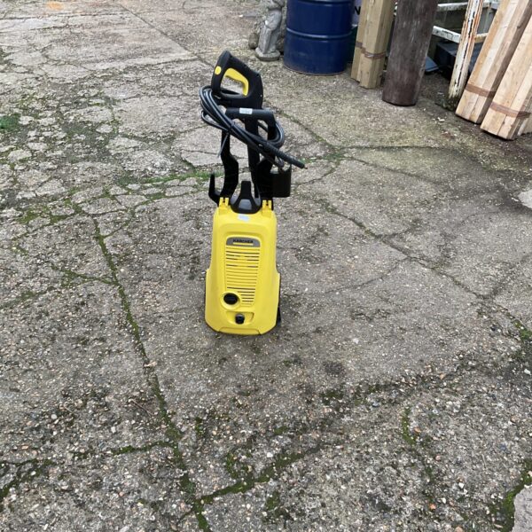Yellow Karcher pressure washer for garden and patio cleaning.