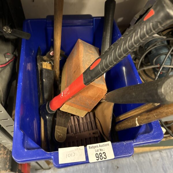 Assorted hand tools in a blue box, including hammers.