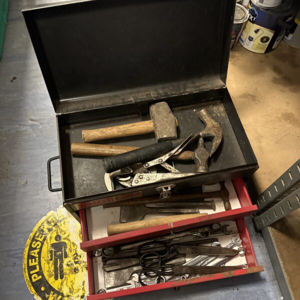 Vintage Talco toolbox filled with various hand tools for workshop storage.