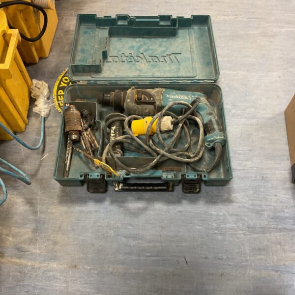 Makita rotary hammer drill in original carrying case.