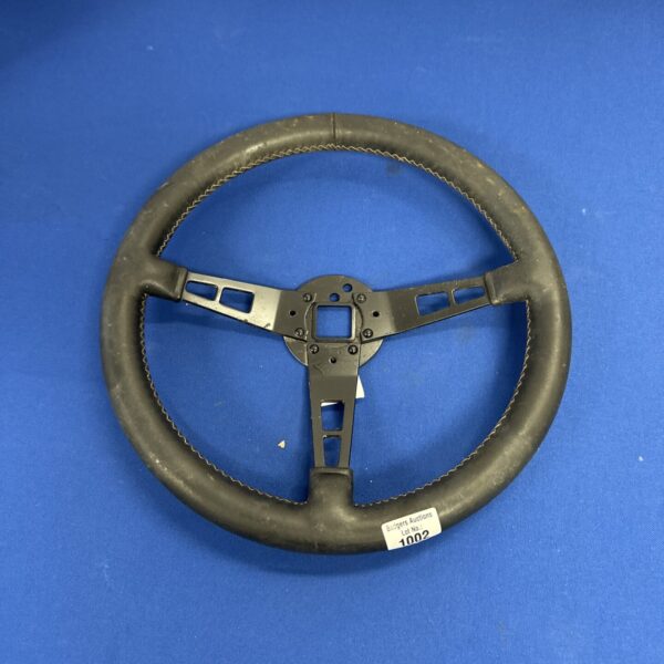 Vintage steering wheel for classic car restoration project.
