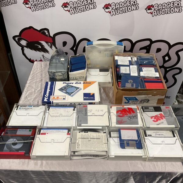 Vintage floppy discs and drive for retro computing.
