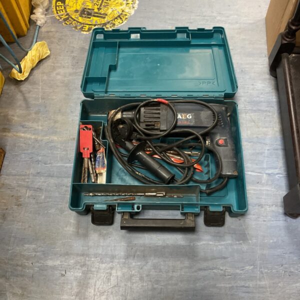 Makita hammer drill in original carrying case, power tool.