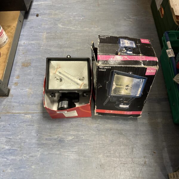 Used outdoor security light with plastic casing and grill.