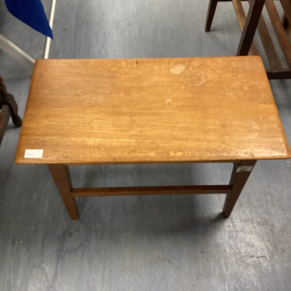 Vintage oak coffee table with signs of wear.