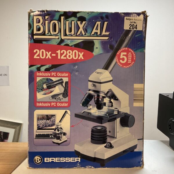 Close-up of a vintage BioLux microscope with magnification settings.