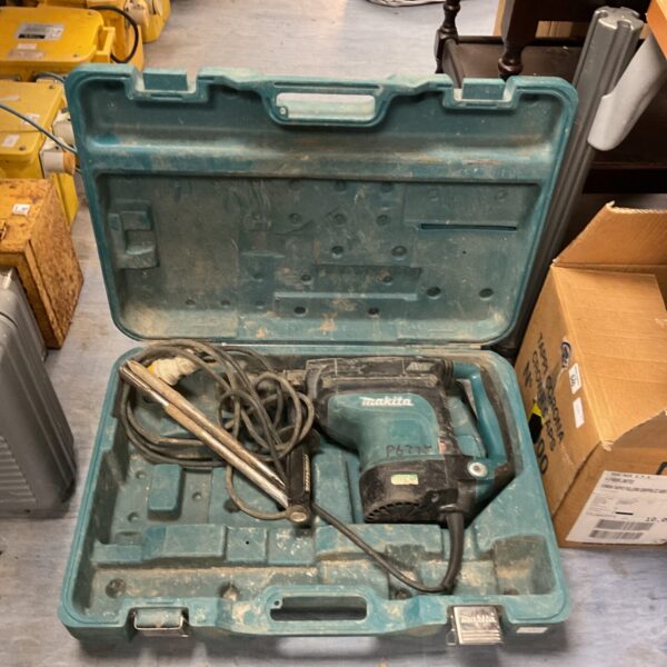 Makita rotary hammer drill in original carry case.