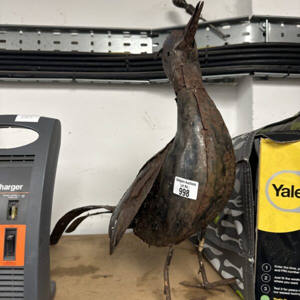 Vintage tin pheasant garden ornament with weathered metal finish.
