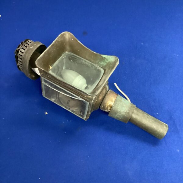 Vintage railway wall light with metal cage and glass lens.