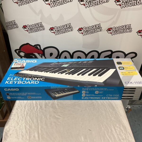 Casio CTK-1100 keyboard in its original box, vintage electronic instrument.