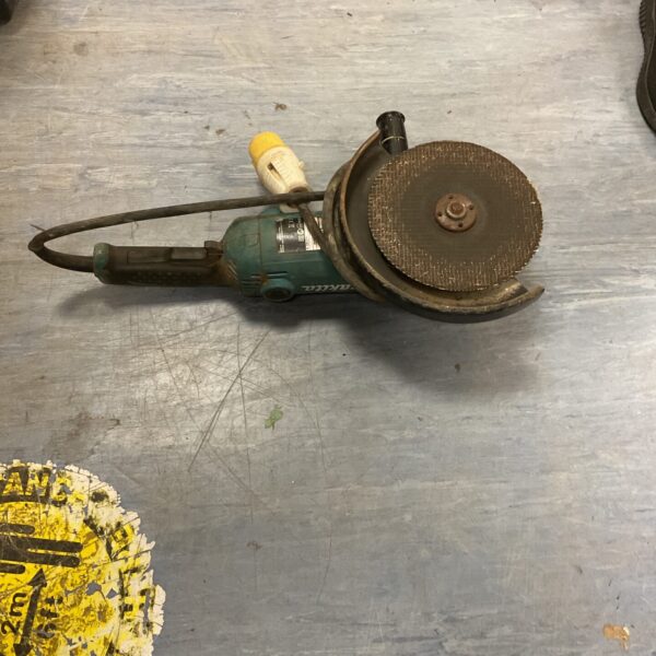 Vintage Makita angle grinder, a powerful metalworking tool in used condition.