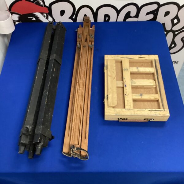 Three wooden artist easels for painting and display.