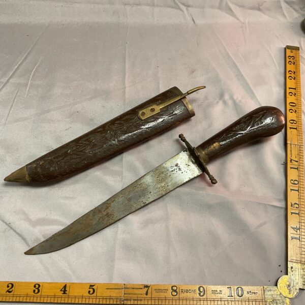 Vintage Indian knife with carved wooden handle and sheath.