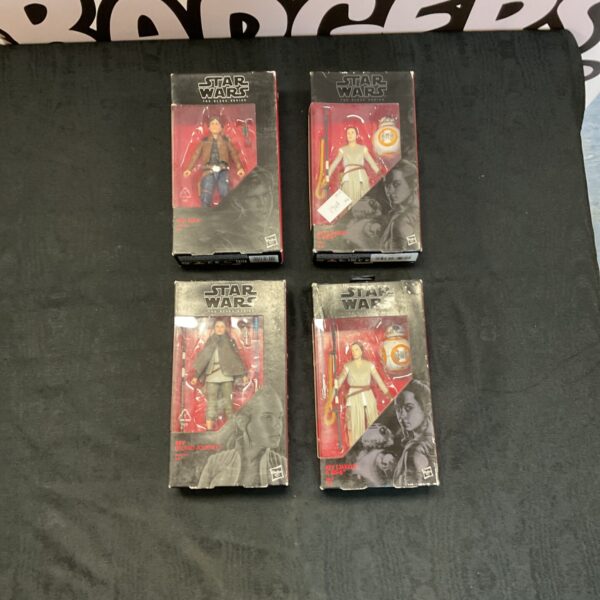 Star Wars Black Series Han Solo and Rey figurines in packaging.