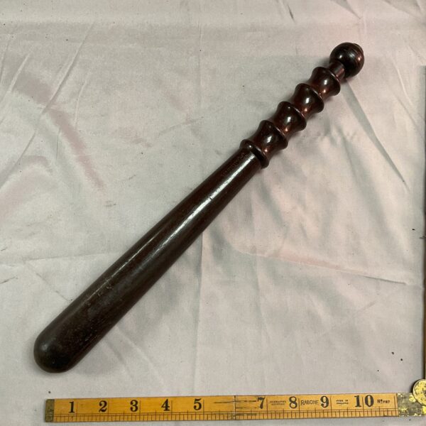 Vintage wooden police truncheon, classic law enforcement baton.