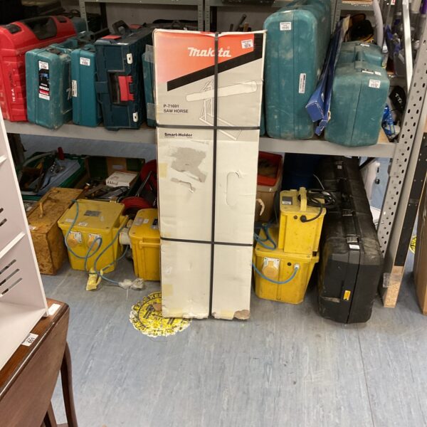 Makita saw horse in a workshop storage setting.