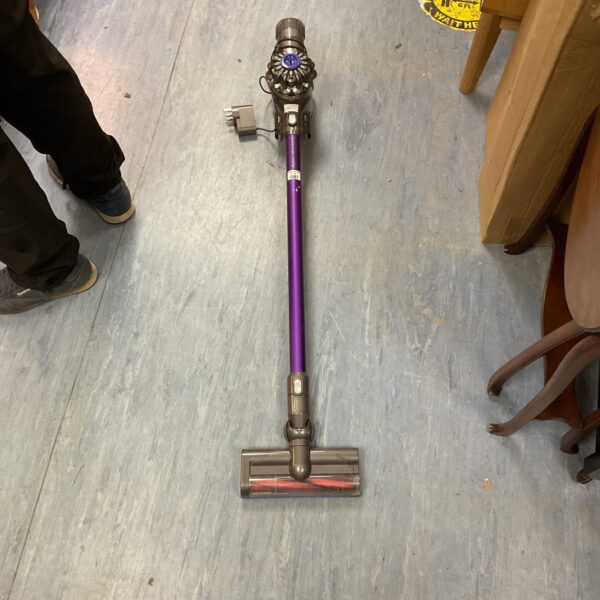 Front view of a grey Dyson V6 Animal cordless vacuum cleaner.