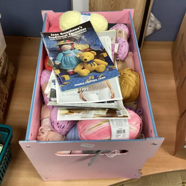 Large lot of colourful knitting wool and vintage patterns for crafting.