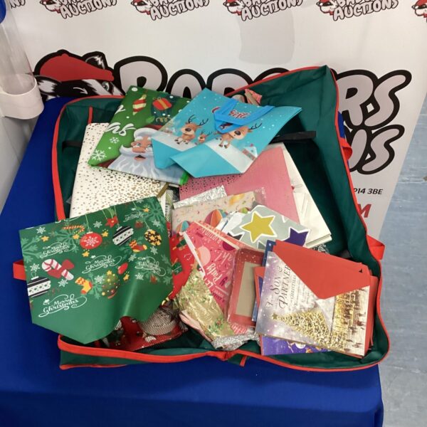A colourful lot of Christmas cards, wrapping paper, and gift bags.