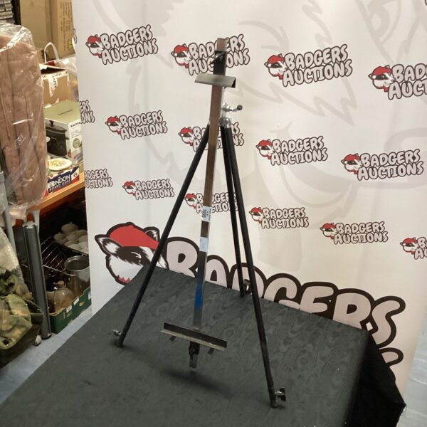 Metal artist easel with tripod base for painting and display.