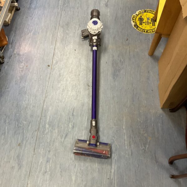 Front view of a purple Dyson V8 cordless vacuum cleaner.