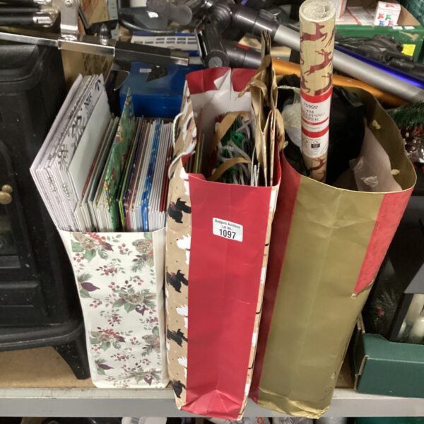 A lot of colourful Christmas wrapping paper and gift bags.