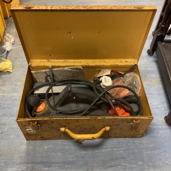 Vintage electric planer in its original carrying case, showing wear.