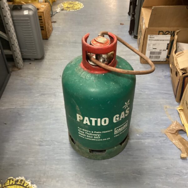 Used 13kg Calor gas bottle with regulator for outdoor heating.