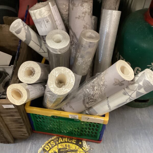 Floral patterned wallpaper rolls for home decor projects.