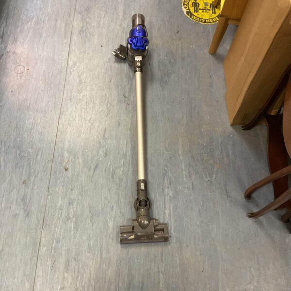 Front view of a grey Dyson V8 cordless vacuum cleaner.
