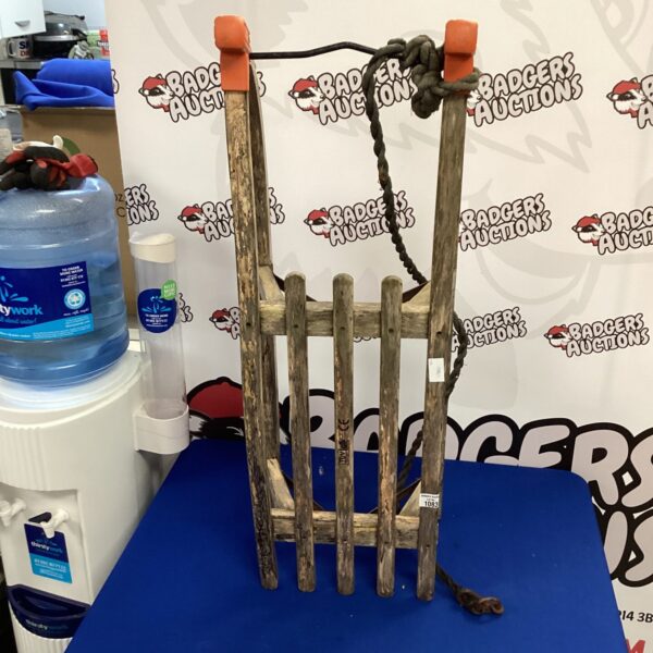 Vintage TVU wooden sledge with curved front.