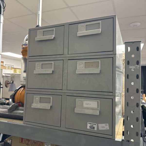 Three grey metal filing cabinets for office storage.
