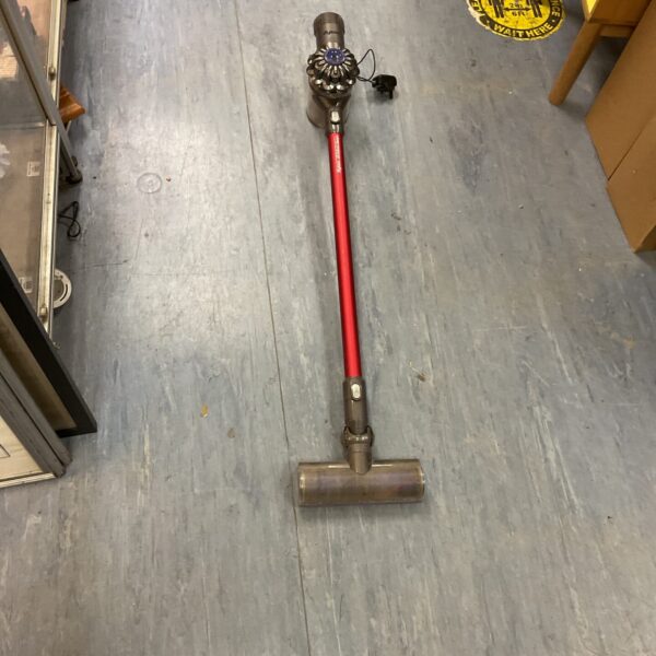 Red Dyson V6 Total Clean cordless vacuum cleaner for auction.