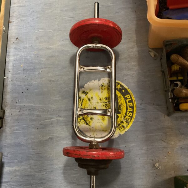 Vintage dumbbell weight bar with red cast iron weights.