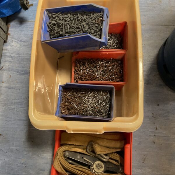 Mixed lot of assorted nails and cargo straps for DIY projects.